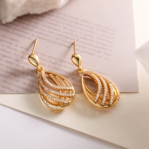 Elegant gold-plated teardrop earrings with hollow lines and pavé-set cubic zirconia crystals