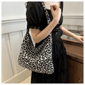 Leopard print canvas tote bag shoulder view showing fabric texture and pattern