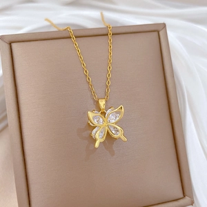 Luxurious hollow butterfly pendant necklace with zircons on soft silk backdrop