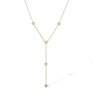 Macro detail of golden Y-shaped necklace featuring five small heart charms on a fine chain