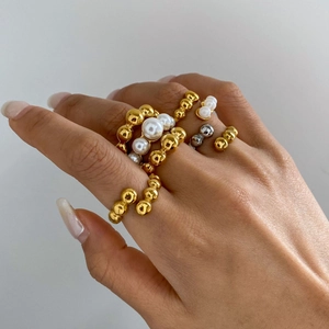 Elegant gold and silver titanium rings with pearls and beads for a layered jewelry look