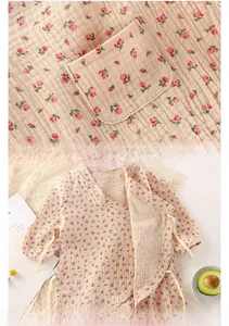 Detail of baby floral cotton jumpsuit with side tie design and small pocket