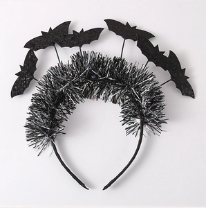 Detail of Halloween headband with silver tinsel and five black bat accents for party decor