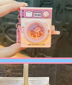 Detail view of cartoon cat-themed washing machine keychain with light feature