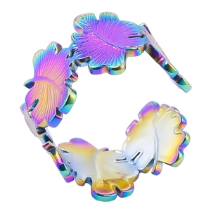 Macro detail of rainbow stainless steel leaf pattern on the adjustable open ring