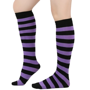Close-up of purple and black striped knee-high socks showing knit texture on model