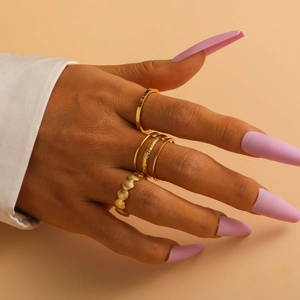 Detailed view of elegant gold titanium steel rings with hollow moon and shell patterns