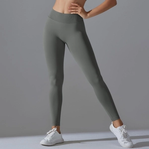 Detail of high-waisted seamless sage green yoga leggings with supportive wide waistband