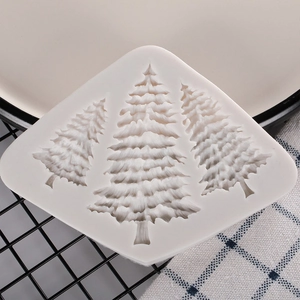 Macro view of white silicone mold with three Christmas tree cavities for cake decorating