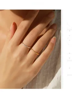 Detail of minimalist gold and silver slim stackable rings on hand with sandblasted finish