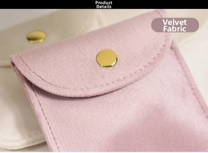 Close-up of velvet jewelry pouches with gold snap buttons and premium stitching details