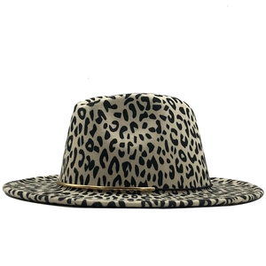 Detailed view of leopard print fedora hat featuring black string and gold metal accent
