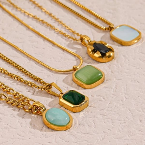 Detailed flat lay of vintage stainless steel necklaces with varied natural stone pendants