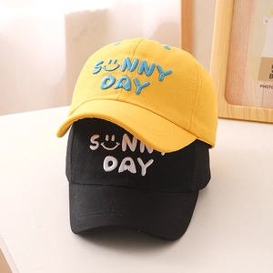 Detail of Sunny Day smile embroidery on breathable cotton yellow and black baseball caps
