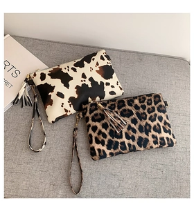 Chic clutch bags featuring animal prints like cow and leopard patterns with fringe details