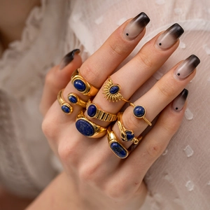 Detailed view of vintage gold rings with lapis lazuli stones and sunburst design
