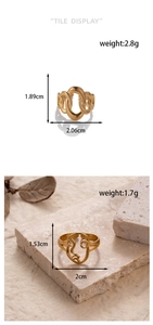 Detail view of golden heart and chain link rings with size and weight specifications
