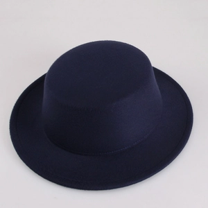 Top view of dark blue wool felt boater hat with flat brim and smooth texture