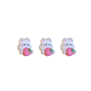 Three cute resin rabbit charms holding pink strawberries for DIY craft accessories