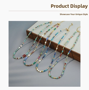 Detail view of colorful turquoise and coral beaded necklaces with gold accents