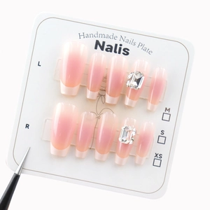 Pink ombré French press-on nails with luxury crystal accents and a long trapezoid shape
