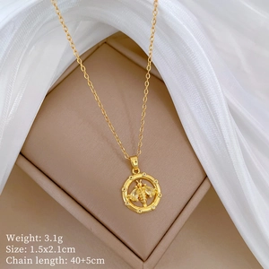 Detailed view of a gold bee pendant necklace with product dimensions on a jewelry box