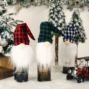Three Christmas gnome wine bottle covers in red green black white plaid fabric