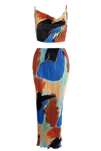 Detailed close-up of pleated texture and abstract colorful print on two-piece set