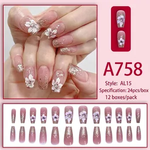 Faux ongles dégradés rose et violet avec fleurs blanches et paillettes dorées