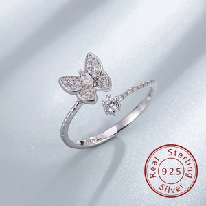 Macro detail of S925 sterling silver butterfly ring with hallmark and sparkling zircons