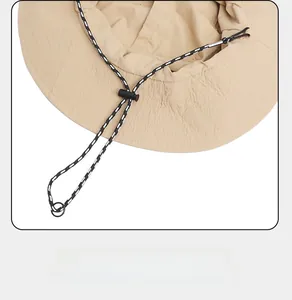 Detail of adjustable windproof rope and toggle on beige outdoor sun hat interior