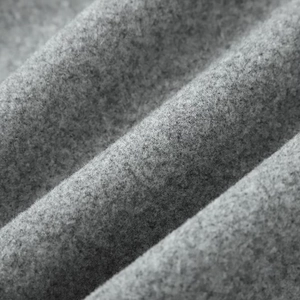 Macro view showing the soft texture and fiber detail of grey felt wool jacket fabric