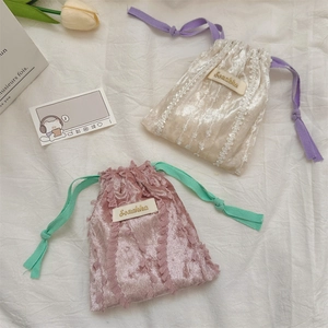 Close-up of velvet drawstring pouch with elegant lace edges and Sozakka embroidery