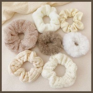 Detail of high-elasticity hair scrunchies in cream and brown plush corduroy textures