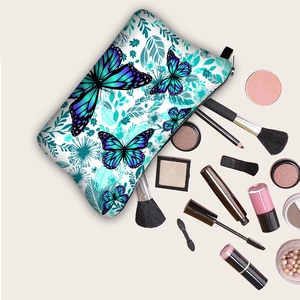 Travel makeup bag with blue butterfly print and top zipper closure for daily toiletries