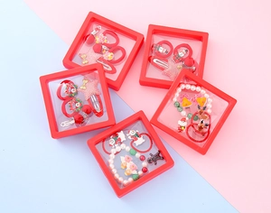 Detailed view of kids Christmas hair accessories in a red square gift box set