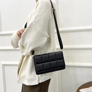 Chic black quilted square shoulder bag with adjustable strap shown on model lifestyle