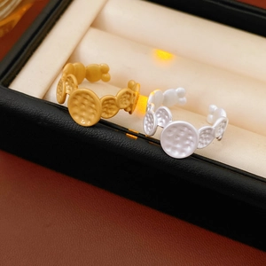 Detailed macro shot of gold and silver hammered texture adjustable open rings