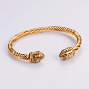 Two-tone twisted cable wire bracelet with gold-plated metal caps in a minimalist design