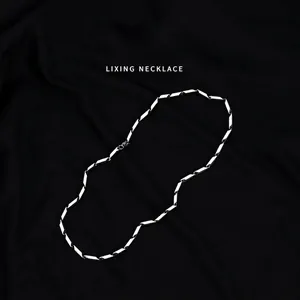 Minimalist stainless steel diamond-shaped link chain necklace for men on black fabric