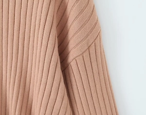 Detail of ribbed knit fabric texture and drop shoulder seam on pink sweater