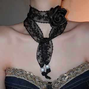 Detail of black lace choker necklace featuring a 3D rose and faux pearl charms
