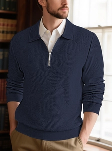Detail of navy blue half-zip polo sweater featuring embossed diamond textured knit fabric