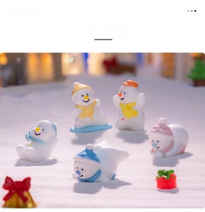 Detailed view of five mini resin snowmen with colorful hats in a winter DIY snow scene