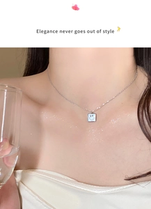 Close-up of a silver smiley face necklace on a female neck for elegant daily styling