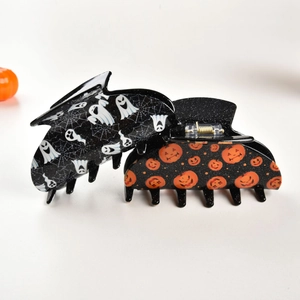 Halloween claw clips featuring white ghost spiderweb and orange pumpkin patterns