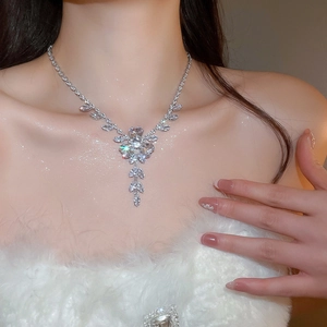 Detailed view of zircon flower and wheat tassel necklace worn on model for wedding occasions