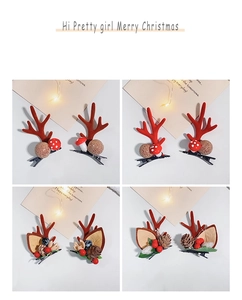 Close-up of Christmas hair clip set with reindeer antlers, berries and pine cones