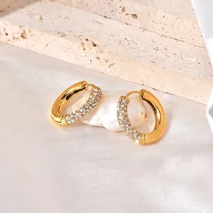 Chic gold hoop earrings with white zircon pavé setting on creamy silk and pearl background