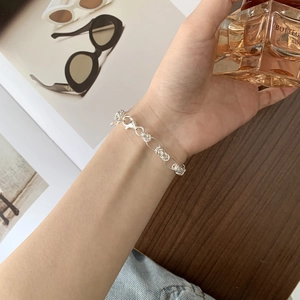 Detail of S925 sterling silver handmade woven bracelet with lobster clasp on wrist